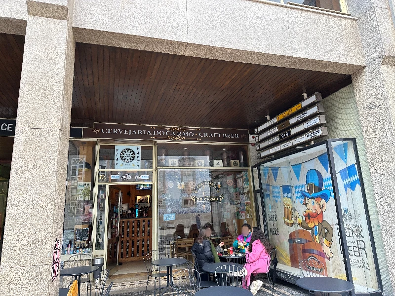 Exterior of Carmo Beer Bar on Praça de Carlos Alberto, Porto, with the Carmo Church visible across the square