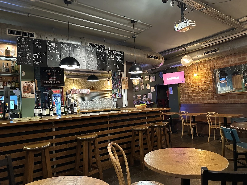 Bar interior at Viriato Seville showing nine taps and warm lighting